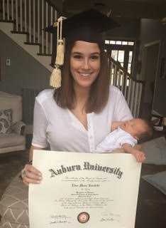 young mom holding diploma and baby