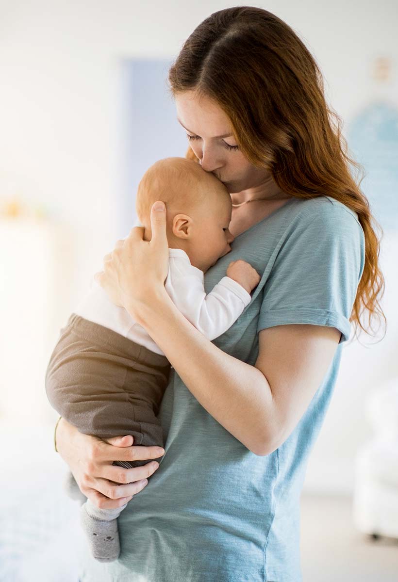 young mom kissing baby